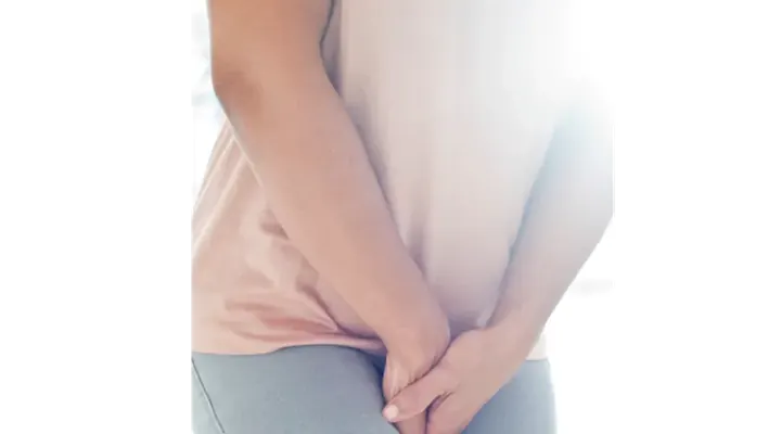Female bending over and holding onto pants in uncomfortable position